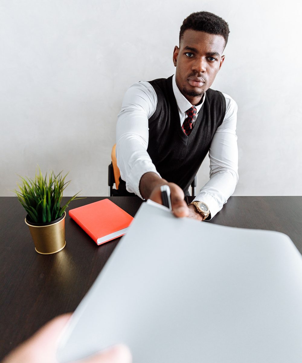 Kenyan client receiving visa approval news from a consultant
